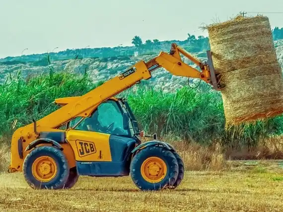Telehandler lifting a load on a site