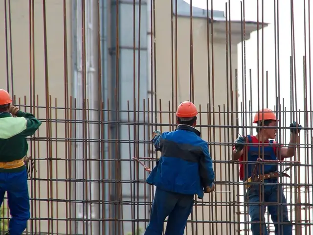 Steel fixers tying a rebar cage by hand