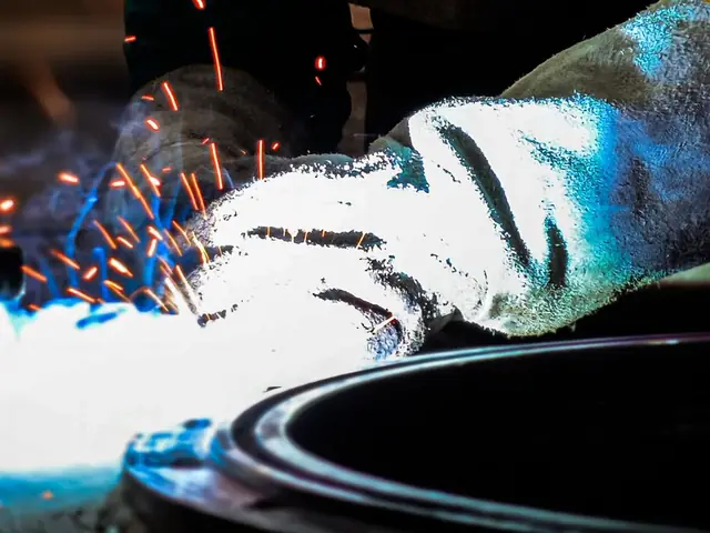 Metalwork in progress at a workshop bench, sparks flying