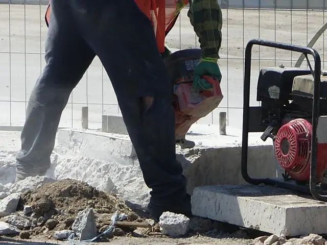 Petrol cut-off saw cutting a concrete kerb