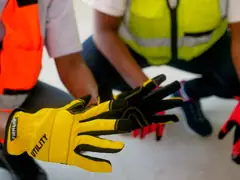 Close-up of hands in yellow and black work gloves