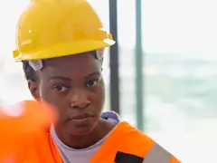 Site worker in a yellow hard hat and hi-vis vest