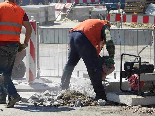 Road crew cutting concrete with a petrol cut-off saw, a high-noise task