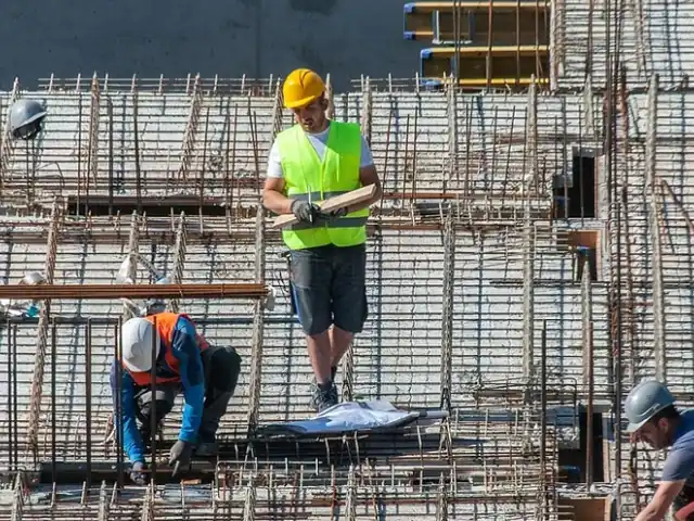 Steel fixers working across a rebar mat