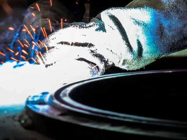 Welder’s leather gauntlets beside a fresh weld
